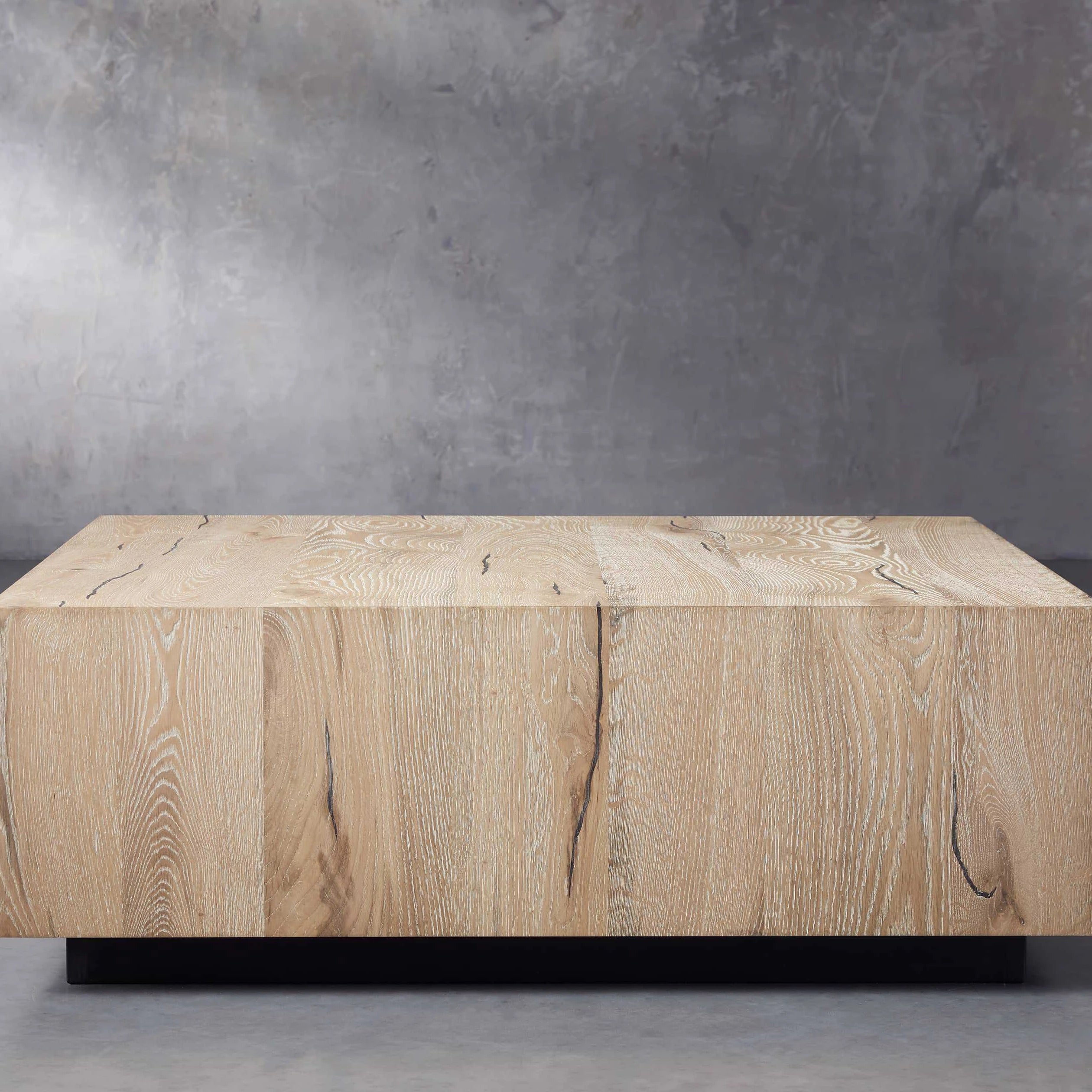 A cozy lounge area brightened by the presence of a wooden rustic coffee table